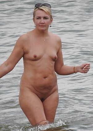 Russian mature nudist 50 years old with very small breasts looks cute for her age.