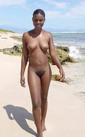 Black teen nudist with very hairy cunt poses naked on the oceanfront
